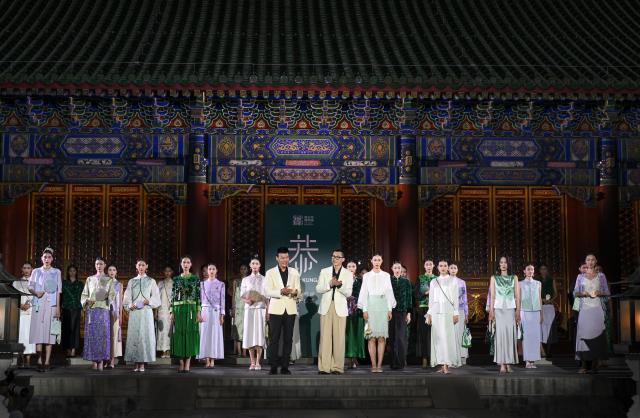 (250715) -- BEIJING, July 15, 2025 (Xinhua) -- Models and designers greet the audience during a fashion show held at the Prince Kung's Palace Museum in Beijing, capital of China, July 14, 2025. The fashion show is inspired by elements of the Prince Kung's Palace Museum and Chinese intangible cultural heritages, displaying 37 concept creations as well as 35 neo-Chinese ready-to-wear and accessories. (Xinhua/Jin Liangkuai)
