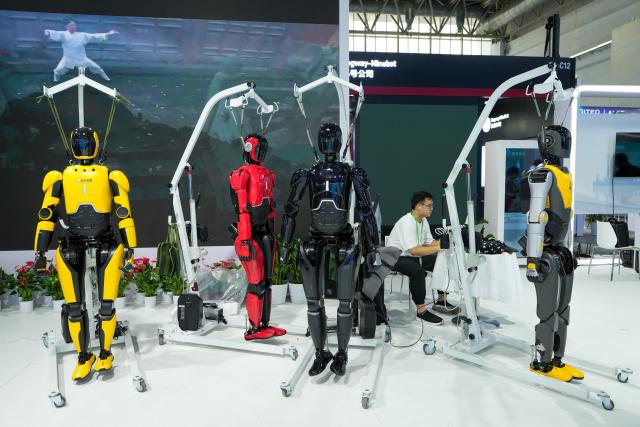 (250715) -- BEIJING, July 15, 2025 (Xinhua) -- A staff member works at an exhibition area for humanoid robot industrial chain of Hubei Province at the digital technology section of the upcoming third China International Supply Chain Expo (CISCE) in Beijing, capital of China, July 14, 2025. The third China International Supply Chain Expo (CISCE), scheduled on July 16-20 in Beijing, is expected to focus on supply chains of advanced manufacturing, clean energy, smart vehicles, digital technology, healthy life and green agriculture. (Xinhua/Ju Huanzong)