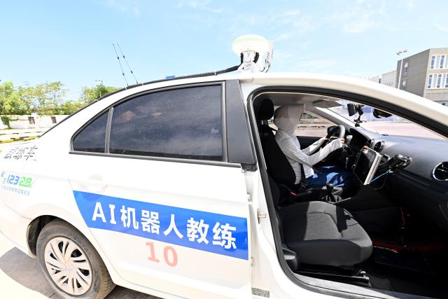 (250715) -- DONGYANG, July 15, 2025 (Xinhua) -- This photo taken on July 5, 2025 shows an AI-driven training vehicle at the Xinlong driving school in Dongyang, east China's Zhejiang Province. The driving school has introduced an AI-assisted teaching system, which includes AI-driven training vehicles, indoor driving simulators, and AI-powered data management system. Equipped with 16 vehicle-borne radars and visual assistance system, each AI-driven training vehicle serves as an intelligent alternative to a driving coach, providing comprehensive and safe guidance for trainees. (Photo by Bao Kangxuan/Xinhua)