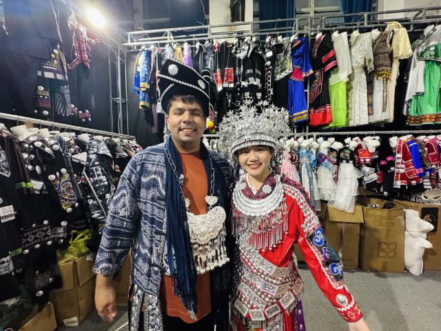 (250715) -- GUIYANG, July 15, 2025 (Xinhua) -- German sustainability researcher Alexander Kuch tries on Miao batik and silver accessories while participating in a "Village T" fashion show in Kaili, southwest China's Guizhou Province, July 5, 2025. TO GO WITH "Feature: German youth explores sustainable heritages in southwest China province" (Xinhua)