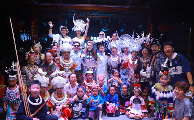 (250715) -- GUIYANG, July 15, 2025 (Xinhua) -- International youths participate in a "Village T" fashion show in Kaili, southwest China's Guizhou Province, July 5, 2025. TO GO WITH "Feature: German youth explores sustainable heritages in southwest China province" (Xinhua)