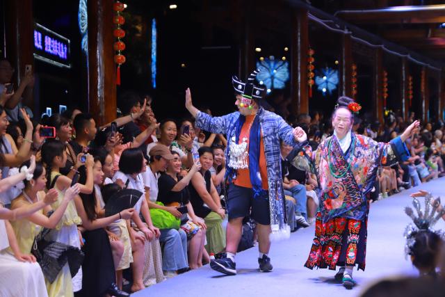 (250715) -- GUIYANG, July 15, 2025 (Xinhua) -- German sustainability researcher Alexander Kuch participates in a "Village T" fashion show in Kaili, southwest China's Guizhou Province, July 5, 2025. TO GO WITH "Feature: German youth explores sustainable heritages in southwest China province" (Xinhua)