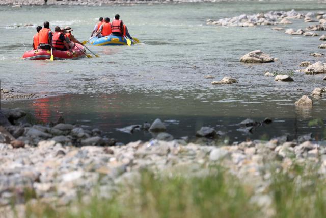 (250716) -- HUIXIAN, July 16, 2025 (Xinhua) -- People raft in inflatable boats on Jiangling River in Huixian County, northwest China's Gansu Province, July 15, 2025. (Xinhua/Chen Bin)