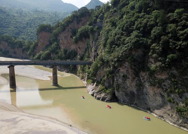 (250716) -- HUIXIAN, July 16, 2025 (Xinhua) -- An aerial drone photo taken on July 15, 2025 shows people rafting in inflatable boats on Jiangling River in Huixian County, northwest China's Gansu Province. (Xinhua/Ma Ning)