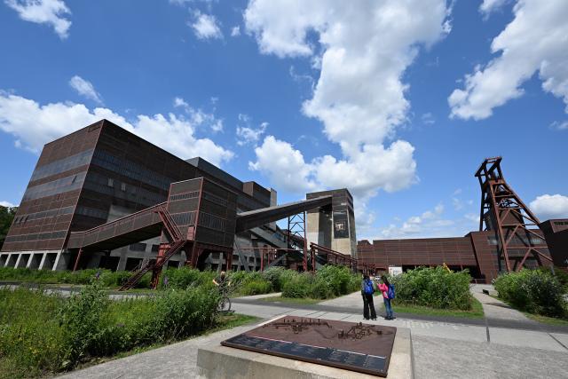 (250716) -- ESSEN, July 16, 2025 (Xinhua) -- People walk in the Zollverein coal mine industrial complex in Essen, Germany, July 15, 2025. (Xinhua/Lian Yi)