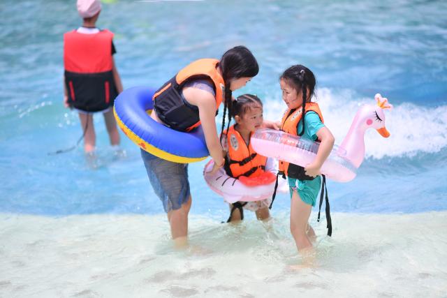 (250716) -- KUNMING, July 16, 2025 (Xinhua) -- People have fun at a water park in Wenshan City, Wenshan Zhuang and Miao Autonomous Prefecture, southwest China's Yunnan Province, July 15, 2025. Known for its stunning nature beauty, Yunnan Province has cultivated a summer tourism industry, offering tourists diverse experiences amid forests, snow-capped mountains, wetlands, and flower fields. (Photo by Xiong Pingxiang/Xinhua)