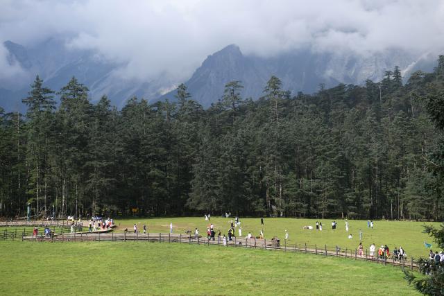 (250716) -- KUNMING, July 16, 2025 (Xinhua) -- Tourists have fun at Yulong Snow Mountain scenic area in southwest China's Yunnan Province, July 14, 2025. Known for its stunning nature beauty, Yunnan Province has cultivated a summer tourism industry, offering tourists diverse experiences amid forests, snow-capped mountains, wetlands, and flower fields. (Photo by Zhao Qingzu/Xinhua)