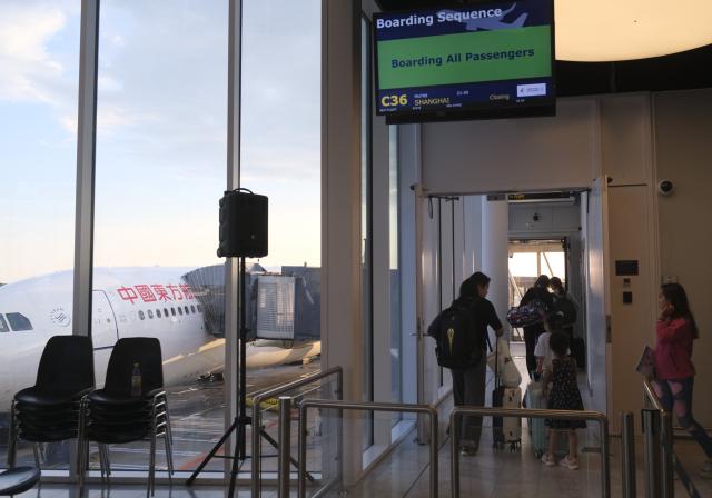 (250718) -- COPENHAGEN, July 18, 2025 (Xinhua) -- Passengers queue to board the Flight MU708 to Shanghai of China at the Copenhagen Airport, in Copenhagen, Denmark, on July 17, 2025. China Eastern Airlines on Thursday launched a new direct route between China's Shanghai and Denmark's Copenhagen, strengthening air connectivity between the two countries.
   TO GO WITH "China Eastern Airlines launches Shanghai-Copenhagen route" (Xinhua/Zhang Yuliang)