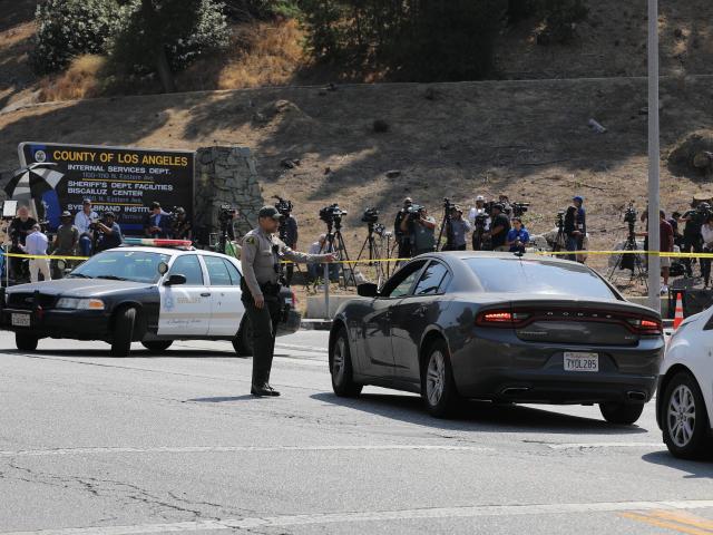 (250718) -- LOS ANGELES, July 18, 2025 (Xinhua) -- A deputy stands guard after an explosion at a training facility of the Los Angeles County Sheriff's Department in Los Angeles County, California, the United States, on July 18, 2025. Three deputies were killed Friday morning in an explosion at a police training facility in Southern California, authorities confirmed. (Photo by Qiu Chen/Xinhua)