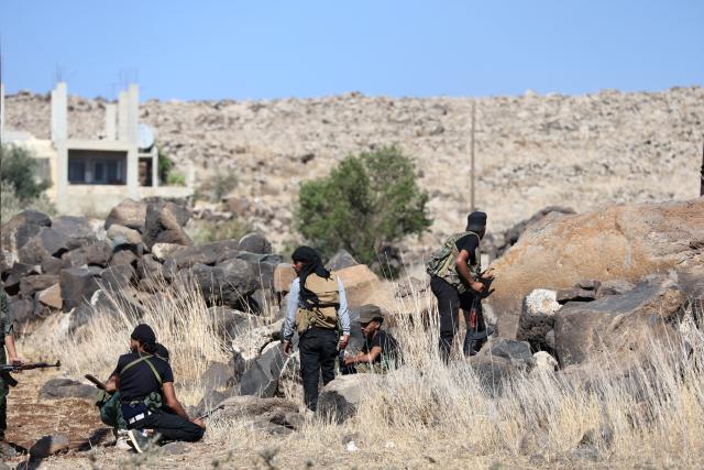 (250718) -- SWEIDA, July 18, 2025 (Xinhua) -- Tribal fighters take positions during clashes in the town of Wolgha, western countryside of Sweida, southern Syria, on July 18, 2025. The Syrian interim authorities on Friday issued a call for restraint amid escalating violence in the southern province of Sweida, pledging to deploy forces to contain the conflict. (Str/Xinhua)