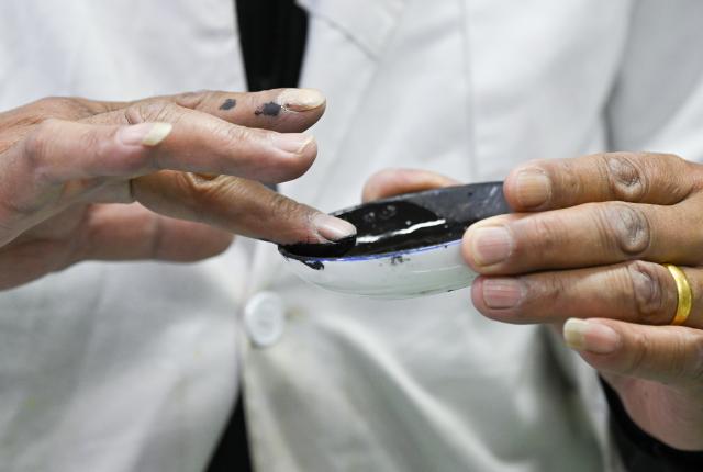 (250719) -- LHASA, July 19, 2025 (Xinhua) -- A member of an expert team on experimental repairing of Pattra-leaf Scriptures grinds pigments for repairing at Potala Palace in Lhasa, capital of southwest China's Xizang Autonomous Region, May 25, 2025. Pattra-leaf Scriptures, or scriptures written on pattra leaves (often in Sanskrit), is important reference documents for research on the cultural broadcasting and history of south and central Asia. Their contents not only cover Buddhism classics, but also relate to cultures, arts, philosophy, medical science and astronomy.
   The Potala Palace houses nearly 40,000 collections of ancient books and documents in multiple languages. Among the most significant collections are scriptures written on around 30,000 pattra leaves, which, however, have posed for great challenges for repairing due to long time of wearing. 
   In 2018, the State Administration of Cultural Heritage (SACH) started the protection project for ancient documents such as Pattra-leaf Scriptures at Potala Palace. After several years of researches and exploration, experts have made achievement on the repairing of Pattra-leaf Scriptures, discovering the right pattra materials for fixing, ways of making adhesives and colour repairing. (Xinhua/Tenzing Nima Qadhup)
