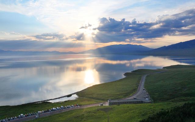 (250719) -- BEIJING, July 19, 2025 (Xinhua) -- An aerial drone photo taken on July 17, 2025 shows the scenery of Sayram Lake in Bortala Mongolian Autonomous Prefecture, northwest China's Xinjiang Uygur Autonomous Region. Nestled in the Tianshan Mountains, Sayram Lake, Xinjiang's highest and largest alpine lake, has entered its peak tourist season in midsummer. (Photo by Zhang Limin/Xinhua)