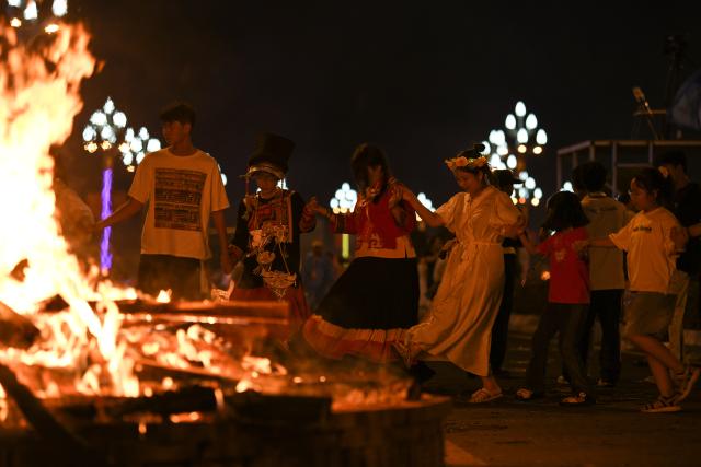 (250719) -- BEIJING, July 19, 2025 (Xinhua) -- People dance around a bonfire in Xichang, Liangshan Yi Autonomous Prefecture in southwest China's Sichuan Province, July 18, 2025. The opening ceremony of the torch festival was held here on Friday. (Xinhua/Xu Bingjie)