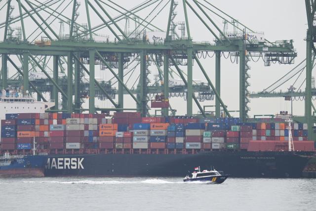 (250917) -- SINGAPORE, Sept. 17, 2025 (Xinhua) -- A ship loads and unloads containers at Singapore's Pasir Panjang terminal on Sept. 17, 2025. Singapore's non-oil domestic exports (NODX) contracted by 11.3 percent in August from a year earlier, following the 4.7 percent decline recorded in July, according to data released Wednesday by Enterprise Singapore. (Photo by Then Chih Wey/Xinhua)
