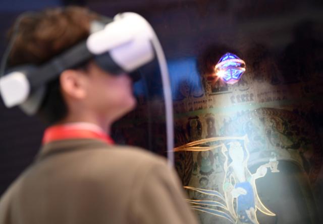 (250918) -- BEIJING, Sept. 18, 2025 (Xinhua) -- A guest watches digital content on Dunhuang research with a VR device during an exhibition of the 2025 World Internet Conference Cultural Heritage Digitalization Forum in Xi'an, northwest China's Shaanxi Province, Sept. 17, 2025.
  The forum opened on Wednesday in Xi'an, home to the world-famous Terracotta Warriors.
  The event attracted approximately 800 participants from over 50 countries and regions, as well as nine international organizations such as UNESCO, World Intellectual Property Organization, International Council on Monuments and Sites, and International Council of Museums.
  The forum focuses on topics of preservation and inheritance, technology and innovation, industry and empowerment, and openness and collaborative governance. (Xinhua/Li Yibo)