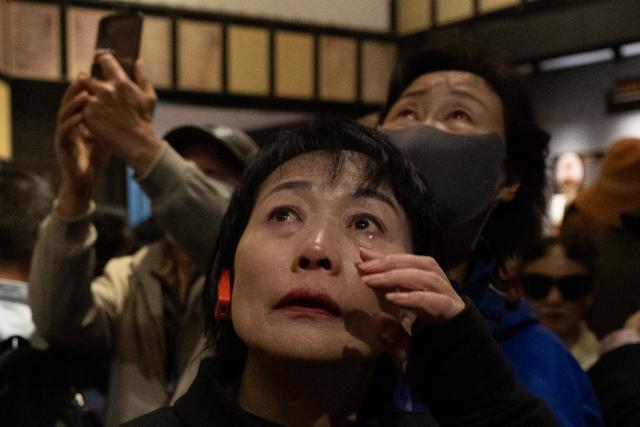 (250918) -- HARBIN, Sept. 18, 2025 (Xinhua) -- A visitor sheds tears at the Exhibition Hall of Evidence of Crimes Committed by Unit 731 of the Japanese Imperial Army in Harbin, capital of northeast China's Heilongjiang Province, Sept. 18, 2025. "The real history is far more brutal than what the film can depict," said Jin Chengmin, curator of the Exhibition Hall of Evidence of Crime Committed by Unit 731 of the Japanese Imperial Army.
  Unit 731, a top-secret biological and chemical warfare research base, was established in the Pingfang District of Harbin, and served as the nerve center for Japanese biological warfare in China and Southeast Asia during World War II.
   Historical records suggest that between 1940 and 1945, at least 3,000 people were used in human experiments by Unit 731, while more than 300,000 people in China were killed by Japan's biological weapons. (Xinhua/Zhang Tao)