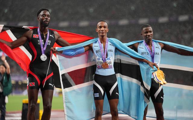 (250918) -- TOKYO, Sept. 18, 2025 (Xinhua) -- Gold medalist Busang Collen Kebinatshipi (C) of Botswana, silver medalist Jereem Richards (L) of Trinidad and Tobago and bronze medalist Bayapo Ndori of Botswana celebrate after the men's 400M final at the 2025 World Athletics Championships in Tokyo, Japan, Sept. 18, 2025. (Xinhua/Jiang Han)