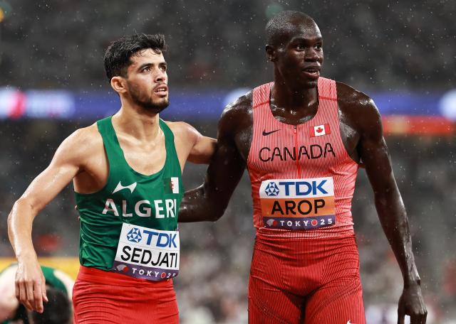 (250919) -- TOKYO, Sept. 19, 2025 (Xinhua) -- Marco Arop (R) of Canada and Djamel Sedjati of Algeria react after the men's 800m semifinal at the 2025 World Athletics Championships in Tokyo, Japan, Sept. 18, 2025. (Xinhua/Jiang Han)