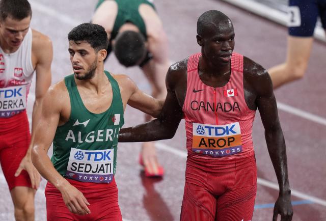(250919) -- TOKYO, Sept. 19, 2025 (Xinhua) -- Marco Arop (R) of Canada and Djamel Sedjati of Algeria react after the men's 800m semifinal at the 2025 World Athletics Championships in Tokyo, Japan, Sept. 18, 2025. (Xinhua/Lui Siu Wai)