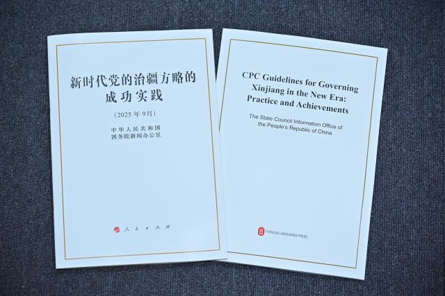 (250919) -- BEIJING, Sept. 19, 2025 (Xinhua) -- This photo taken on Sept. 19, 2025 shows copies of the white paper titled "CPC Guidelines for Governing Xinjiang in the New Era: Practice and Achievements" released by the State Council Information Office (SCIO). (Xinhua/Li Xin)