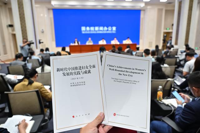 (250919) -- BEIJING, Sept. 19, 2025 (Xinhua) -- This photo shows copies of the white paper titled "China's Achievements in Women's Well-Rounded Development in the New Era" released by the State Council Information Office (SCIO) during a press conference in Beijing, capital of China, on Sept. 19, 2025. (Xinhua/Li Xin)