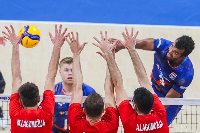 (250920) -- PASAY CITY, Sept. 20, 2025 (Xinhua) -- Michiel Ahyi (1st R) of the Netherlands spikes the ball during the round of 16 match between Türkiye and the Netherlands at the FIVB Men's World Championship 2025 in Pasay City, the Philippines, on Sept. 20, 2025. (Xinhua/Rouelle Umali)
