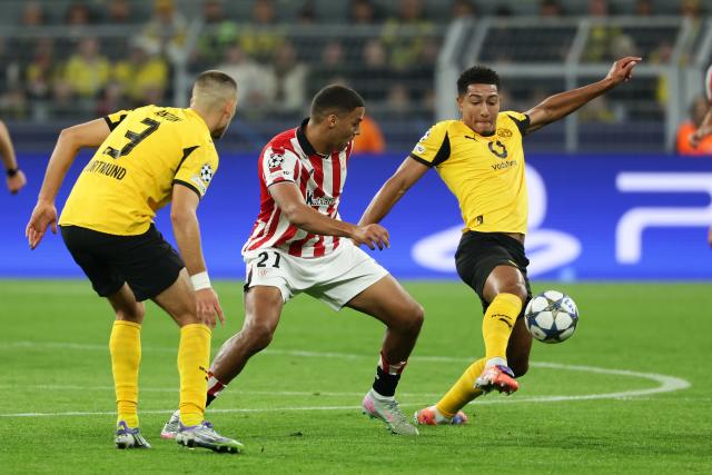 (251002) -- DORTMUND, Oct. 2, 2025 (Xinhua) -- Jobe Bellingham (R) and Waldemar Anton (L) of Borussia Dortmund vie with Maroan Sannadi of Athletic Club during the UEFA Champions League group stage 2nd round match between Borussia Dortmund and Athletic Club in Dortmund, Germany, Oct. 1, 2025. (Photo by Joachim Bywaletz/Xinhua)