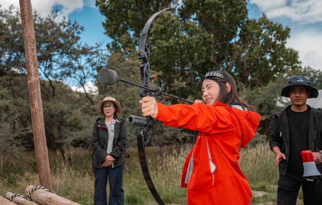 (251002) -- LHASA, Oct. 2, 2025 (Xinhua) -- Tourists try an archery game at a "Lingka" festival in Qonggyai County of Shannan, southwest China's Xizang Autonomous Region, on Sept. 13, 2025. "Lingka" means "garden" in the Tibetan language. In Xizang, people follow a tradition of spending the "Lingka" time during which they camp out and have picnics in parks or suburbs. 
    Nowadays, this traditional folk custom has developed into a new form of cultural tourism as well as a vibrant lifestyle. (Xinhua/Tenzin Nyida)