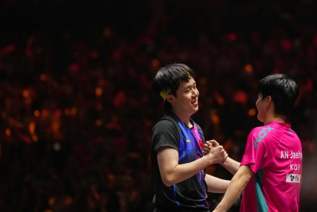 (251002) -- BEIJING, Oct. 2, 2025 (Xinhua) -- Wang Chuqin (L) of China and An Jaehyun of South Korea greet each other after the men's singles round of 16 match at 2025 World Table Tennis (WTT) China Smash in Beijing, China, Oct. 2, 2025. (Xinhua/Ju Huanzong)