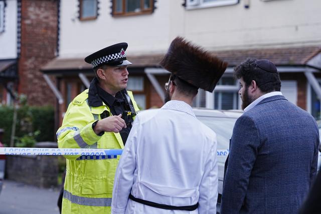(251002) -- MANCHESTER(BRITAIN), Oct. 2, 2025 (Xinhua) -- A police officer (L) is pictured on the scene at Heaton Park Hebrew Congregation Synagogue in Manchester, Britain, Oct. 2, 2025. Police confirmed Thursday afternoon that the attack outside the Heaton Park Hebrew Congregation Synagogue on Middleton Road in Crumpsall, Manchester, has been declared a terrorist incident. (Xinhua)