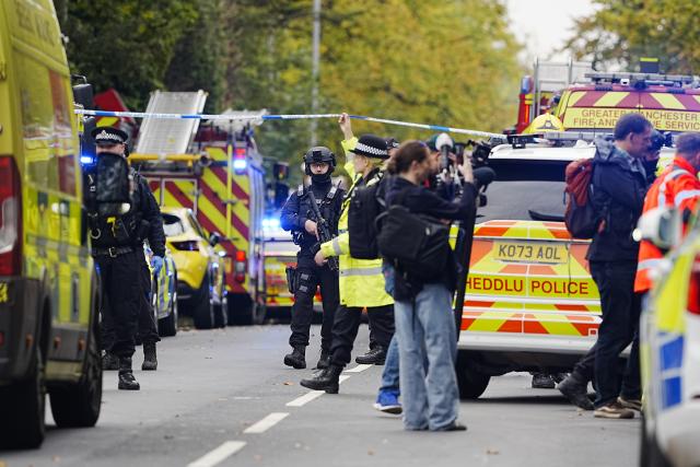 (251002) -- MANCHESTER(BRITAIN), Oct. 2, 2025 (Xinhua) -- Police officers and emergency services are pictured on the scene at Heaton Park Hebrew Congregation Synagogue in Manchester, Britain, Oct. 2, 2025. Police confirmed Thursday afternoon that the attack outside the Heaton Park Hebrew Congregation Synagogue on Middleton Road in Crumpsall, Manchester, has been declared a terrorist incident. (Xinhua)