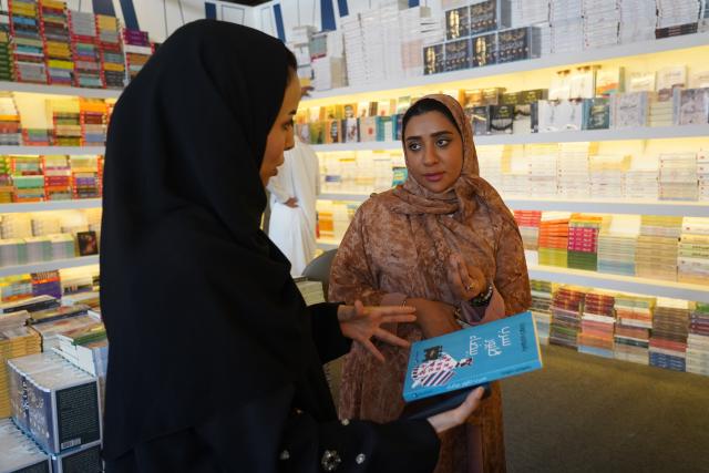 (251002) -- RIYADH, Oct. 2, 2025 (Xinhua) -- Two women talk at the Riyadh International Book Fair 2025 in Riyadh, Saudi Arabia, Oct. 2, 2025. The book fair opened here on Thursday, bringing together over 2,000 local and international publishing houses from more than 25 countries, along with a range of cultural institutions. (Xinhua/Luo Chen)