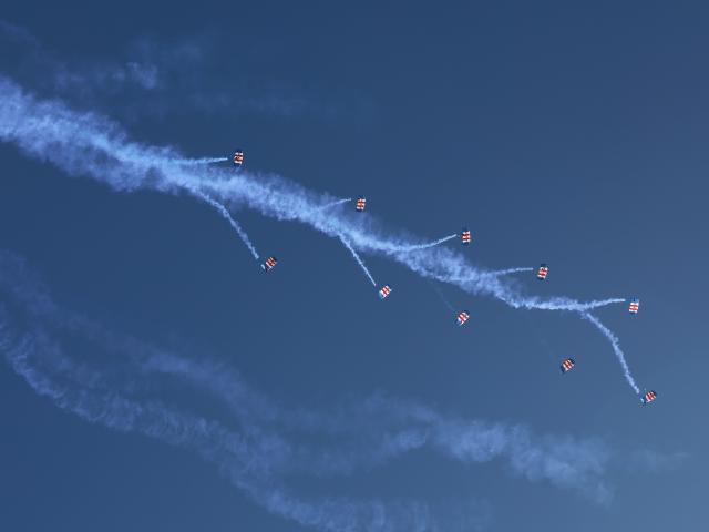 (251004) -- LOS ANGELES, Oct. 4, 2025 (Xinhua) -- Parachutists perform at the Pacific Airshow in the city of Huntington Beach, Orange County, California, the United States, on Oct. 3, 2025. The Pacific Airshow, one of the largest of its kind in the United States, kicked off Friday in Southern California, featuring a lineup of world-class performances. (Photo by Qiu Chen/Xinhua)