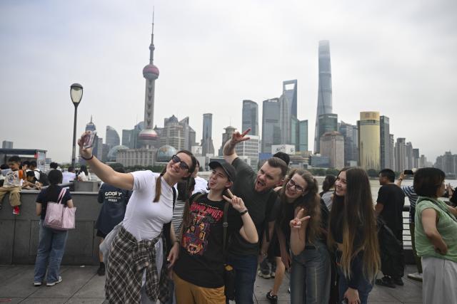 (251004) -- SHANGHAI, Oct. 4, 2025 (Xinhua) -- Tourists from Russia take selfies at the Bund area in east China's Shanghai, Oct. 4, 2025. The eastern Chinese megacity of Shanghai received a whopping 4.1 million overseas visitors from January to August this year.
  The latest tourism boom in the city has resulted from a series of policies that provide greater convenience for international tourists entering China. As one of the country's most famous tourist cities, Shanghai is usually among the first places affected by new policies for the sector.
    According to Shanghai General Station of Immigration Inspection, the airport ports in Shanghai are expected to handle 883,000 inbound and outbound passengers during the National Day holiday from Oct. 1 to 8, which is a daily average of 116,000 passengers, a 22.3 percent increase year on year. (Xinhua/Chen Haoming)