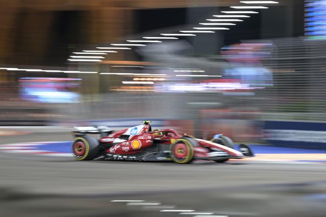 (251006) -- SINGAPORE, Oct. 6, 2025 (Xinhua) -- Ferrari's British driver Lewis Hamilton drives during the Formula 1 Singapore Grand Prix 2025 in Singapore, Oct. 5, 2025. (Photo by Then Chih Wey/Xinhua)