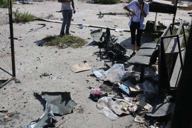 (251006) -- NABATIEH(LEBANON), Oct. 6, 2025 (Xinhua) -- People inspect the wreckage of a vehicle struck by missiles fired by Israeli forces in Nabatieh, southern Lebanon, on Oct. 6, 2025. An Israeli airstrike on southern Lebanon killed two people and wounded another on Monday, the state-run National News Agency (NNA) reported. The NNA said Israeli forces fired two guided missiles at a vehicle in Nabatieh, killing Hassan Atwi and his wife, Zeinab Raslan, whom it described as civilians. The couple had lost their two children earlier in the war with Israel. (Photo by Taher Abu Hamdan/Xinhua)