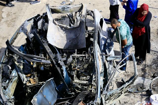 (251006) -- NABATIEH(LEBANON), Oct. 6, 2025 (Xinhua) -- People inspect the wreckage of a vehicle struck by missiles fired by Israeli forces in Nabatieh, southern Lebanon, on Oct. 6, 2025. An Israeli airstrike on southern Lebanon killed two people and wounded another on Monday, the state-run National News Agency (NNA) reported. The NNA said Israeli forces fired two guided missiles at a vehicle in Nabatieh, killing Hassan Atwi and his wife, Zeinab Raslan, whom it described as civilians. The couple had lost their two children earlier in the war with Israel. (Photo by Taher Abu Hamdan/Xinhua)