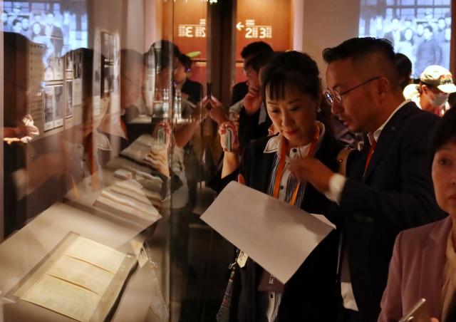 (251009) -- BEIJING, Oct. 9, 2025 (Xinhua) -- People visit an exhibition commemorating the miraculous evacuation of the Palace Museum's collection during Chinese People's War of Resistance against Japanese Aggression more than 80 years ago, in Beijing, capital of China, Sept. 30, 2025. TO GO WITH "Feature: Centennial Palace Museum bridges Chinese across Taiwan Strait" (Xinhua)