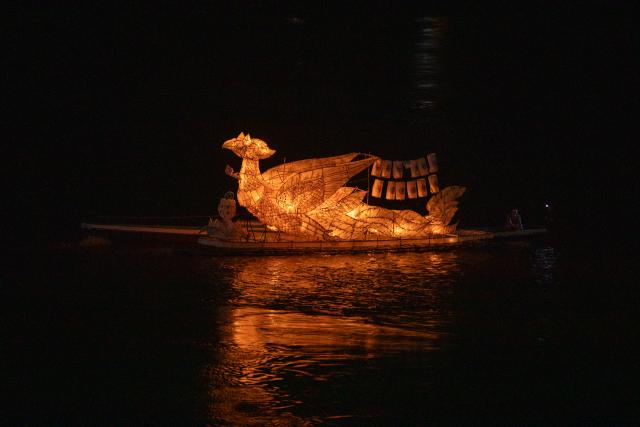 (251009) -- LUANG PRABANG, Oct. 9, 2025 (Xinhua) -- A light boat floats on Mekong River in Luang Prabang, Laos, Oct. 8, 2025. Boun Lai Heua Fai, a light boat festival, was held in the northern Lao world heritage town of Luang Prabang on Wednesday. (Photo by Kaikeo Saiyasane/Xinhua)