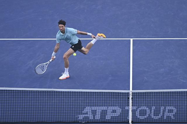 (251010) -- SHANGHAI, Oct. 10, 2025 (Xinhua) -- Arthur Rinderknech of France hits a return to Felix Auger-Aliassime of Canada during the men's singles quarterfinal at the ATP World Tour Shanghai Masters tennis tournament in Shanghai, east China, Oct. 10, 2025. (Xinhua/Chen Haoming)