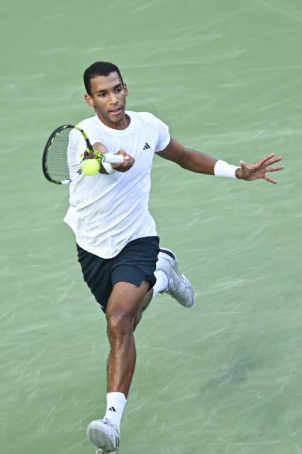 (251010) -- SHANGHAI, Oct. 10, 2025 (Xinhua) -- Felix Auger-Aliassime of Canada hits a return to Arthur Rinderknech of France during the men's singles quarterfinal at the ATP World Tour Shanghai Masters tennis tournament in Shanghai, east China, Oct. 10, 2025. (Xinhua/Chen Haoming)