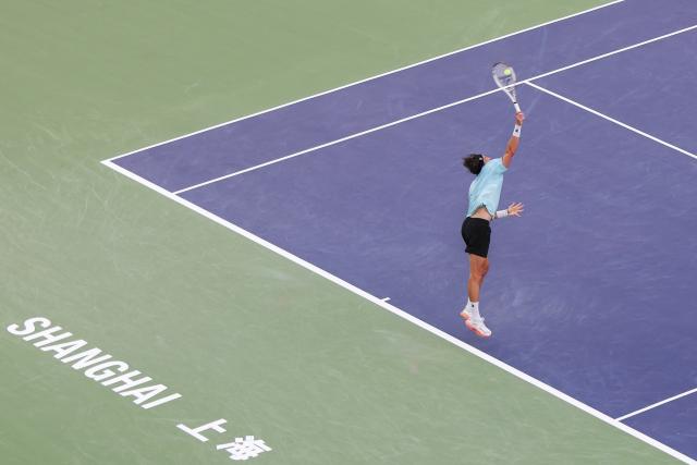 (251010) -- SHANGHAI, Oct. 10, 2025 (Xinhua) -- Arthur Rinderknech of France serves to Felix Auger-Aliassime of Canada during the men's singles quarterfinal at the ATP World Tour Shanghai Masters tennis tournament in Shanghai, east China, Oct. 10, 2025. (Xinhua/Wang Xiang)