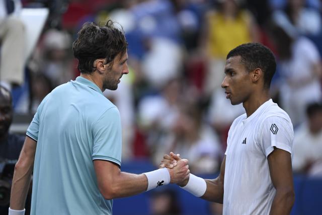 (251010) -- SHANGHAI, Oct. 10, 2025 (Xinhua) -- Arthur Rinderknech (L) of France shakes hands with Felix Auger-Aliassime of Canada after the men's singles quarterfinal at the ATP World Tour Shanghai Masters tennis tournament in Shanghai, east China, Oct. 10, 2025. (Xinhua/Chen Haoming)