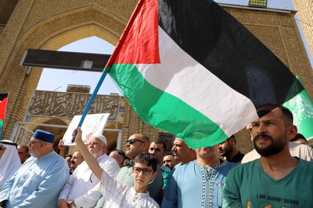 (251010) -- BAGHDAD, Oct. 10, 2025 (Xinhua) -- Iraqis attend a rally to celebrate the ceasefire agreement in Gaza, in Baghdad, Iraq, Oct. 10, 2025. A ceasefire agreement between Israel and Hamas came into effect in the Gaza Strip at 12:00 noon local time (0900 GMT) on Friday, according to sources. (Xinhua/Khalil Dawood)