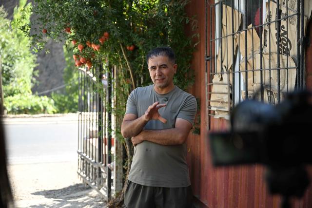 (251011) -- DUSHANBE, Oct. 11, 2025 (Xinhua) -- Villager Kishwar speaks during an interview at his home beside the second-phase section of the China-Tajikistan Highway near Kalai Khumb, Tajikistan, on Sept. 11, 2025. The China-Tajikistan Highway -- also known as the Pamir Highway -- was first built in the 1940s. Stretching more than 1,000 km from Dushanbe to Karasu on the China-Tajikistan border, it is vital for Tajikistan's transport and external links.
   TO GO WITH "Feature: China-Tajikistan Highway a lifeline on the Pamirs" (Xinhua/Li Renzi)