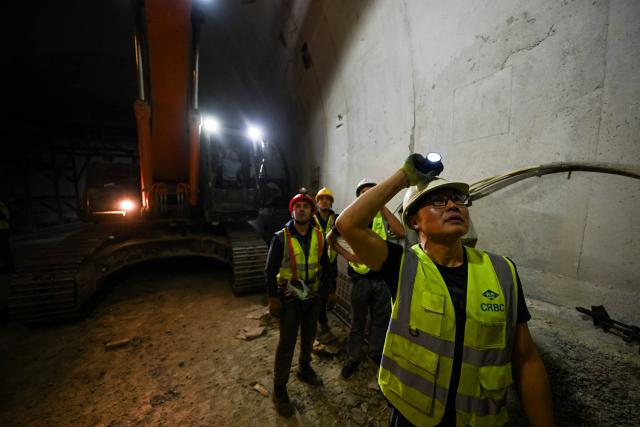 (251011) -- DUSHANBE, Oct. 11, 2025 (Xinhua) -- Workers are on duty at the construction site of the second-phase section of the China-Tajikistan Highway near Kalai Khumb, Tajikistan, on Sept. 11, 2025. The China-Tajikistan Highway -- also known as the Pamir Highway -- was first built in the 1940s. Stretching more than 1,000 km from Dushanbe to Karasu on the China-Tajikistan border, it is vital for Tajikistan's transport and external links.
   TO GO WITH "Feature: China-Tajikistan Highway a lifeline on the Pamirs" (Xinhua/Li Renzi)