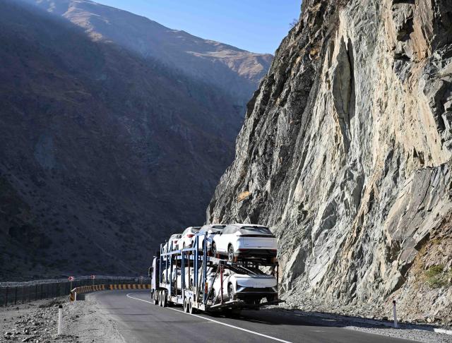 (251011) -- DUSHANBE, Oct. 11, 2025 (Xinhua) -- A vehicle carrying Chinese-brand automobiles travels on the second-phase section of the China-Tajikistan Highway near Kalai Khumb, Tajikistan, on Sept. 11, 2025. The China-Tajikistan Highway -- also known as the Pamir Highway -- was first built in the 1940s. Stretching more than 1,000 km from Dushanbe to Karasu on the China-Tajikistan border, it is vital for Tajikistan's transport and external links.
   TO GO WITH "Feature: China-Tajikistan Highway a lifeline on the Pamirs" (Xinhua/Li Renzi)