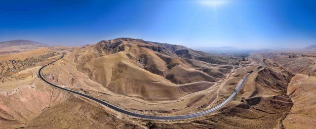 (251011) -- DUSHANBE, Oct. 11, 2025 (Xinhua) -- An aerial drone photo shows part of the first-phase section of the China-Tajikistan Highway near Kalai Khumb, Tajikistan, on Sept. 10, 2025. The China-Tajikistan Highway -- also known as the Pamir Highway -- was first built in the 1940s. Stretching more than 1,000 km from Dushanbe to Karasu on the China-Tajikistan border, it is vital for Tajikistan's transport and external links.
   TO GO WITH "Feature: China-Tajikistan Highway a lifeline on the Pamirs" (Xinhua/Li Renzi)
