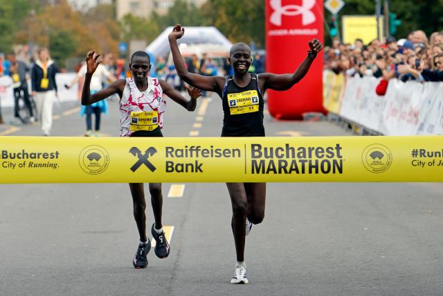 (251013) -- BUCHAREST, Oct. 13, 2025 (Xinhua) -- Beatrice Cherono (R) of Kenya celebrates winning the Bucharest Marathon women's race in Bucharest, Romania, Oct. 12, 2025. (Photo by Cristian Cristel/Xinhua)