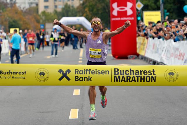 (251013) -- BUCHAREST, Oct. 13, 2025 (Xinhua) -- Romanian runner Nicolae Soare celebrates winning the Bucharest Marathon men's race in Bucharest, Romania, Oct. 12, 2025. (Photo by Cristian Cristel/Xinhua)